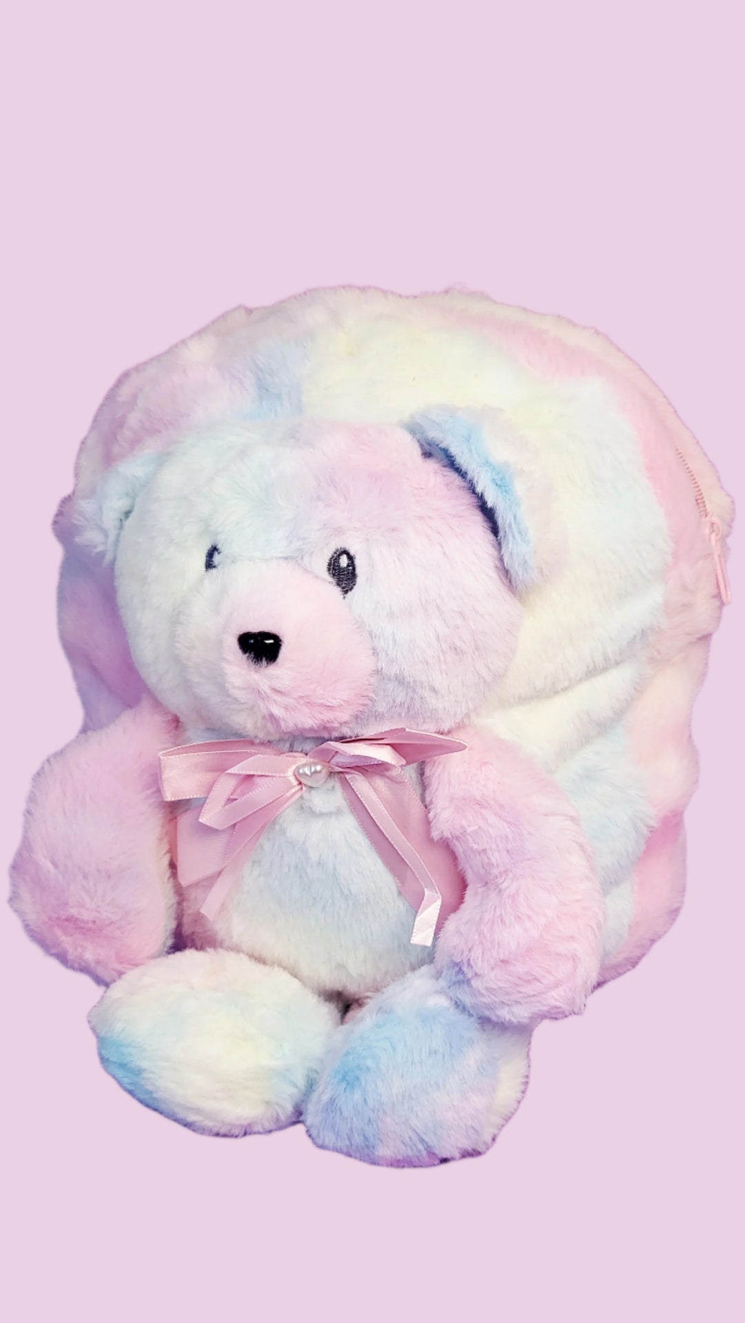 Pastel-colored teddy bear with a bow on a purple background
