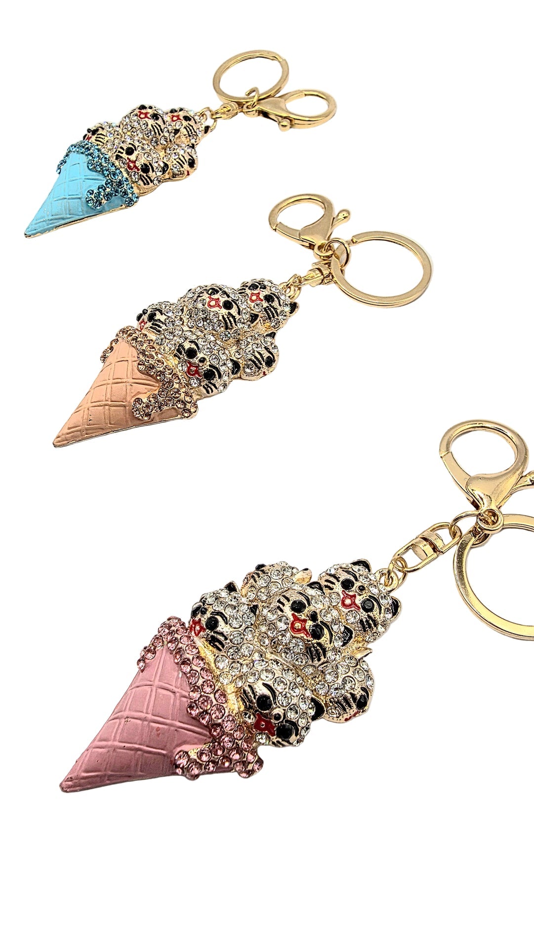 Ice cream cone keychains with decorative elements on a white background